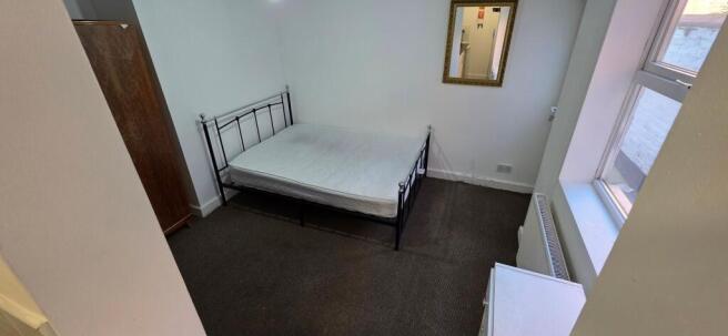 Bright double room with bed and wardrobe...
