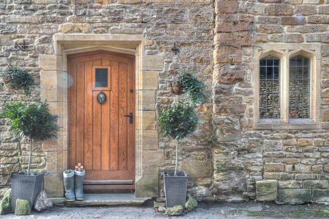 Entrance and stone mullion window