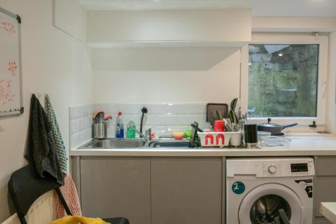 A bright and functional kitchen with a window p...