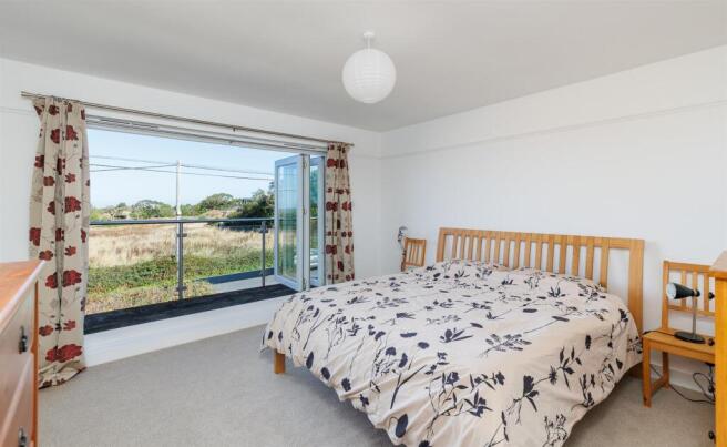 Principal bedroom with balcony and ensuite shower