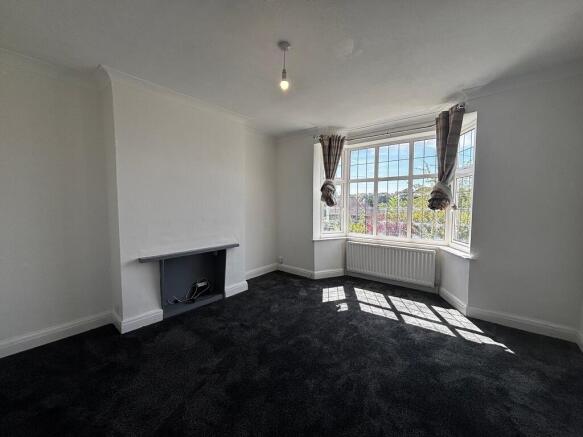Bright living room with a spacious bay window...