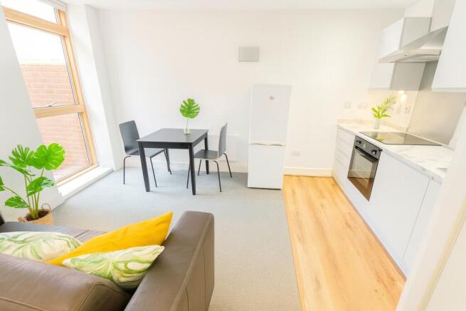 Bright and modern living area featuring a compa...