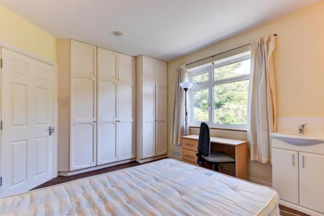 A bright and welcoming bedroom with ample natur...