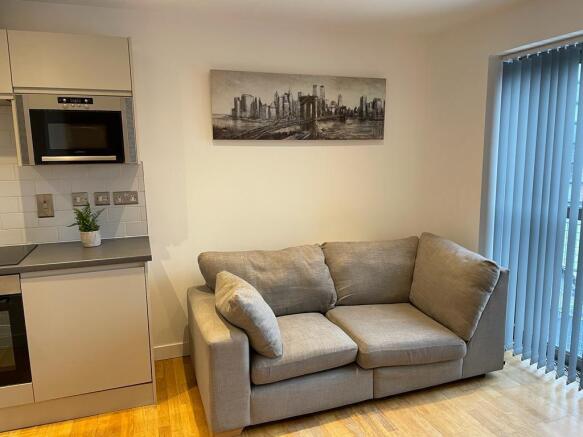 Modern living space with plush sofa and art...