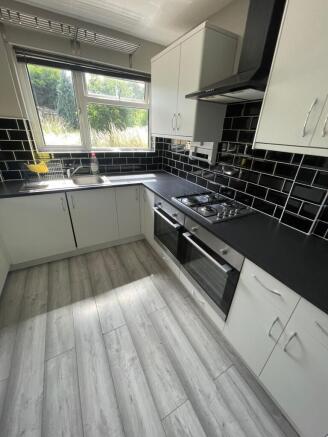 Bright and modern kitchen featuring sleek black...