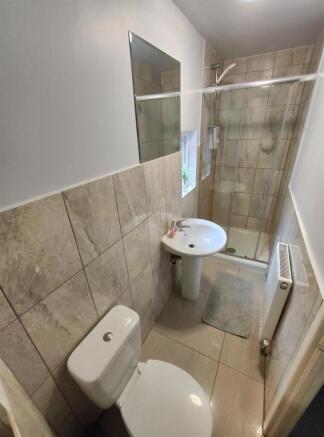 Bright, tiled bathroom with a walk-in shower, p...