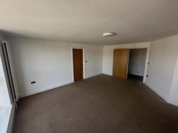 Spacious living room with large window providin...