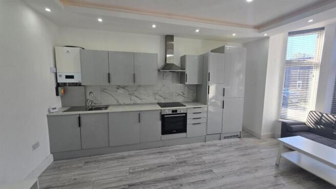 Modern fitted kitchen with sleek grey cabinets...