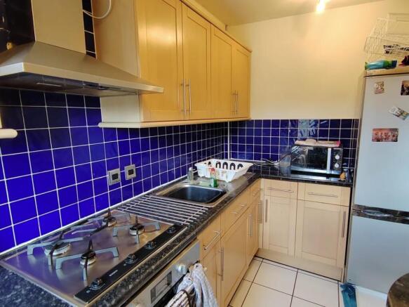 Bright kitchen with vibrant blue tile backsplas...
