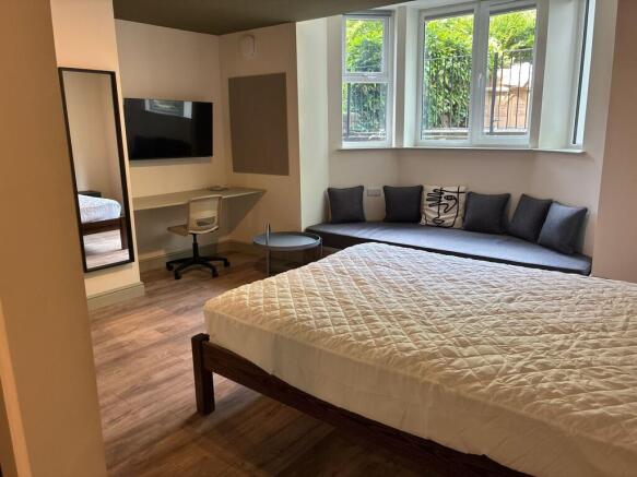 Bright bedroom with stylish window seating area...