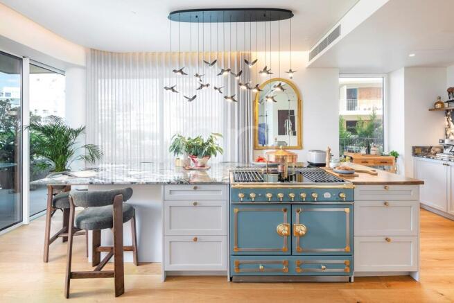 Stylish fitted kitchen with distinctive island and contemporary finishes