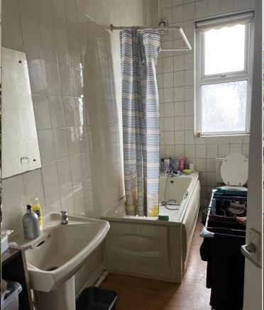 Bright bathroom with a bathtub and shower curta...