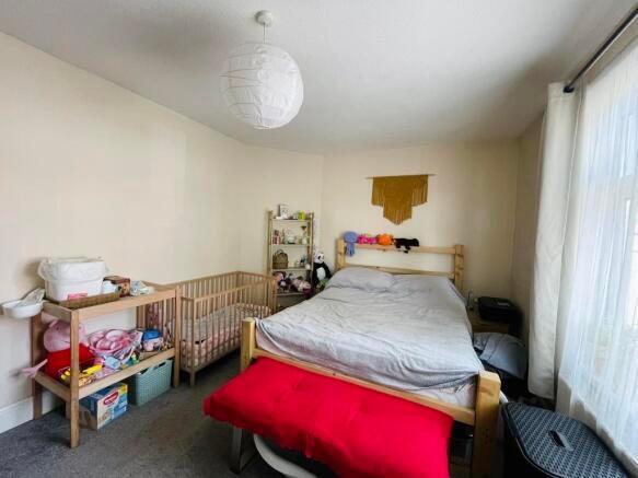 Bright, simply furnished double bedroom with a ...