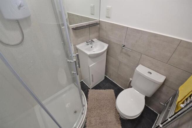 Modern shower room with sleek grey tiling...