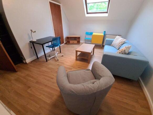 A bright and welcoming living room featuring a ...