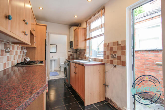 Kitchen with door to garden and bathroom beyond