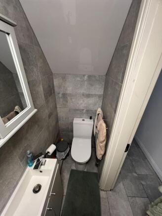 Modern tiled bathroom with sleek white fixtures...