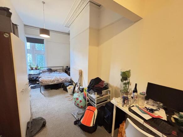 A cozy bedroom with a double bed and a small wo...