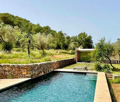 Private 12m swimming pool with sunbathing deck, nestled in a serene Ibiza estate.