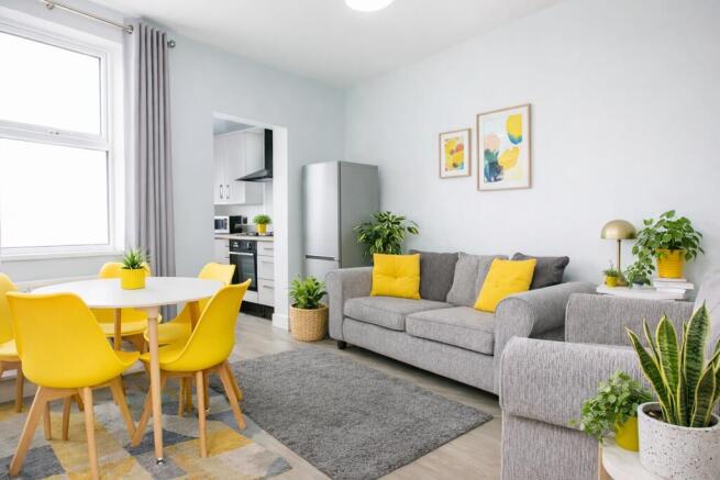 Bright, modern open-plan living area with a com...