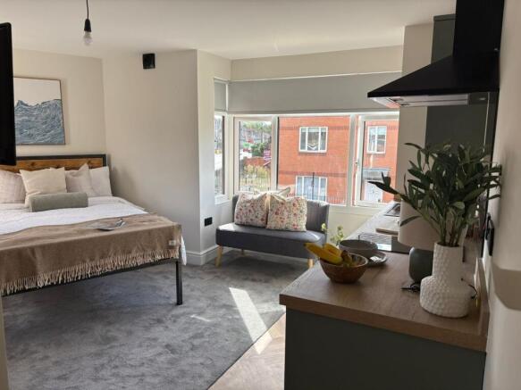 Bright, well-styled bedroom with a comfortable ...
