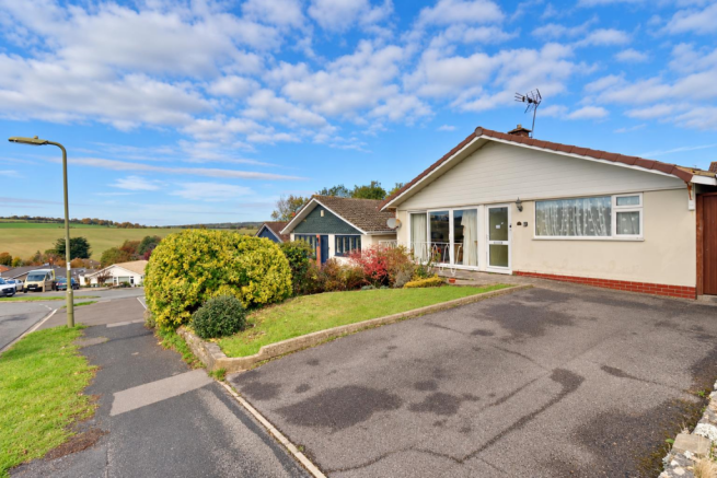 Sunny Suburban Bungalow Overlooking Fields.png