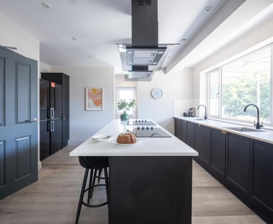 Modern kitchen with large island and big window...