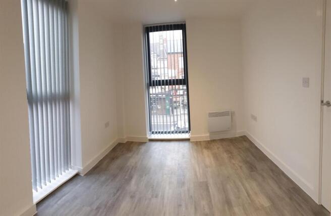 Bright modern bedroom with stylish wood floors...