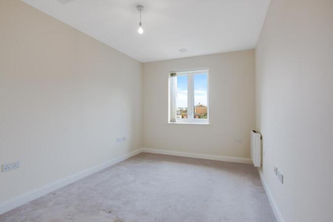 a room with a window and a carpet