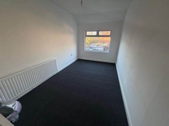 Bright, freshly painted single bedroom with a l...