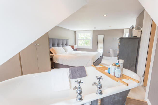 Bedroom 1 with cupboards and bath recess