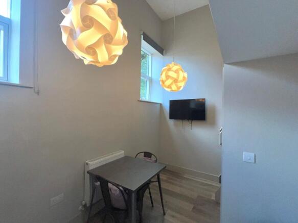 Contemporary communal lounge area with pendant ...