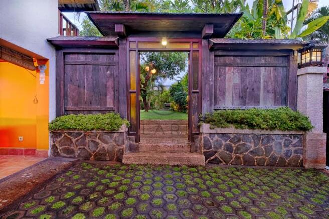 Charming wooden gate opening to a lush garden, per