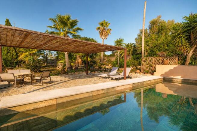 Mediterranean pool with lounge area and nature views near Manacor