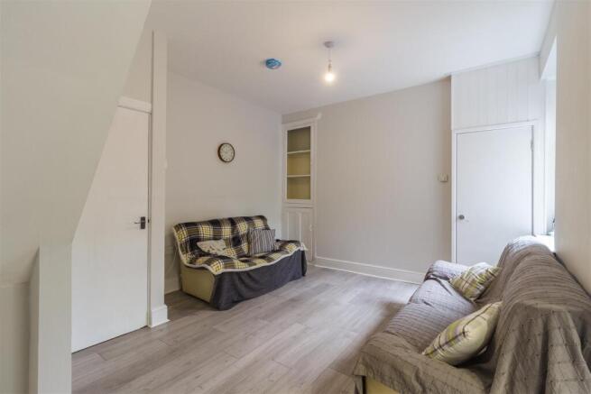 Bright lounge with modern flooring and sofas...