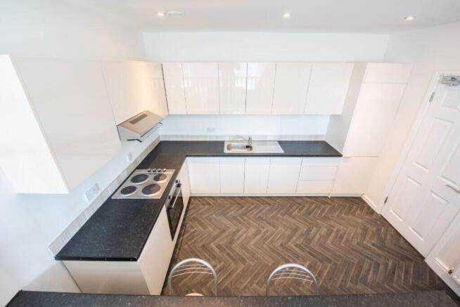 Modern kitchen with sleek white cabinetry...