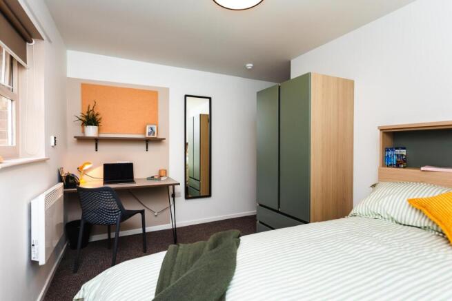 Bright, modern bedroom with a comfortable doubl...