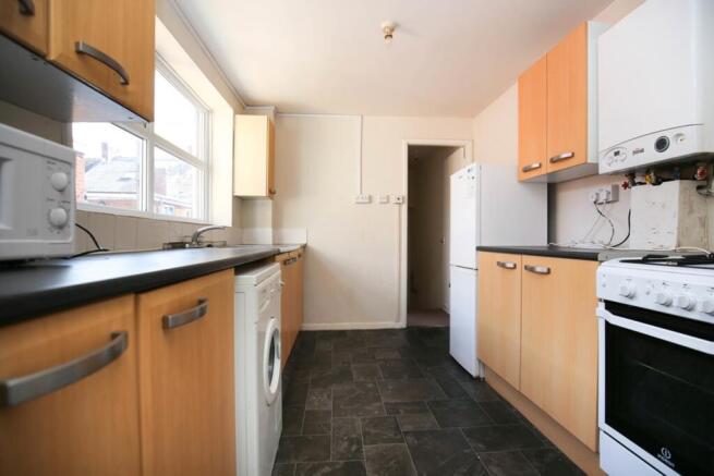 A spacious kitchen with good natural light and ...