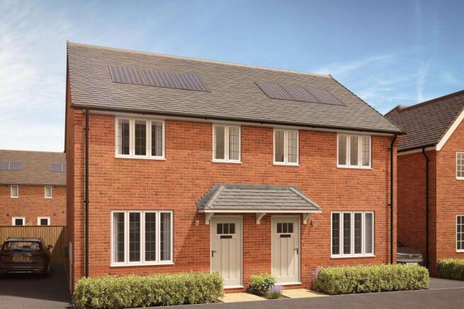 A pair of modern brick semi-detached houses with manicured hedges in the foreground stand against a
