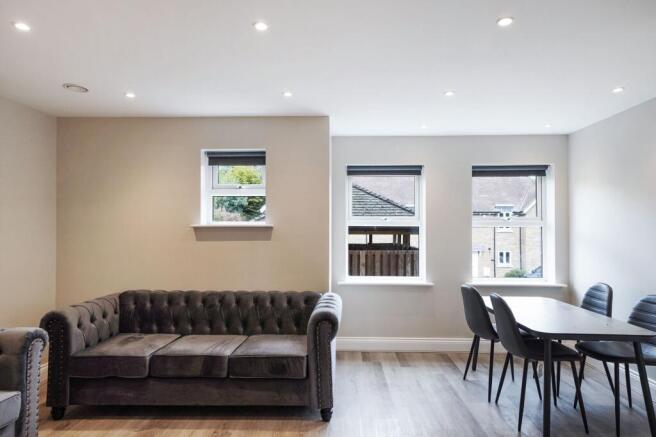 Elegant lounge with plush sofa and dining space...