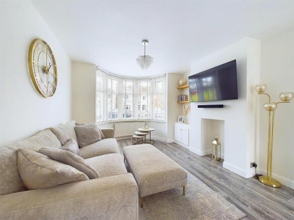 Bright, contemporary living room with a large L...