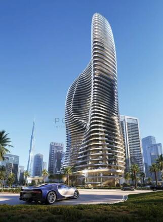A futuristic, twisting skyscraper rises in a citys