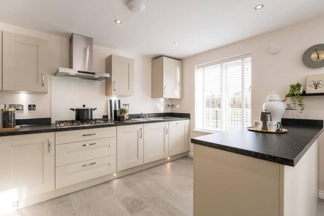 The modern kitchen area features a breakfast bar