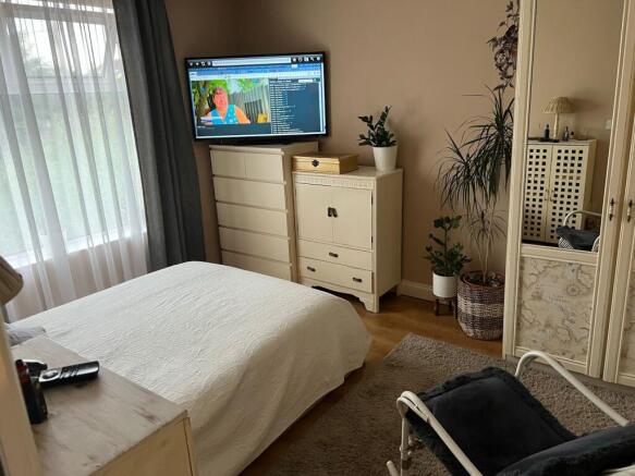 Bright, well-styled bedroom with large window l...