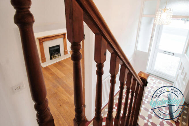 View from staircase to hallway and front sitting r