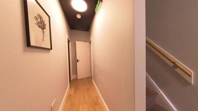 Bright, tidy corridor with light wood flooring,...