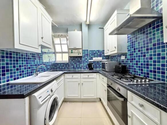 Bright kitchen with vibrant blue mosaic tiles...
