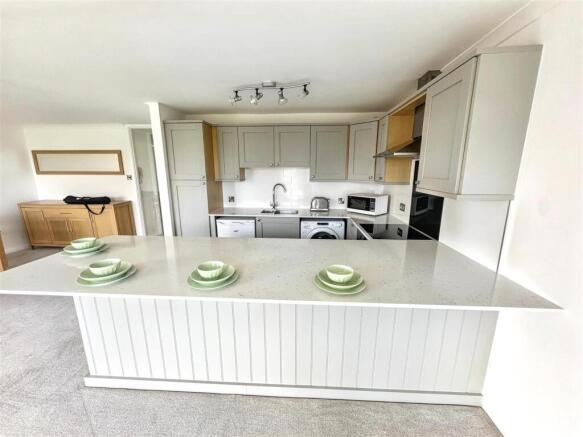 Modern kitchen with stylish breakfast bar islan...