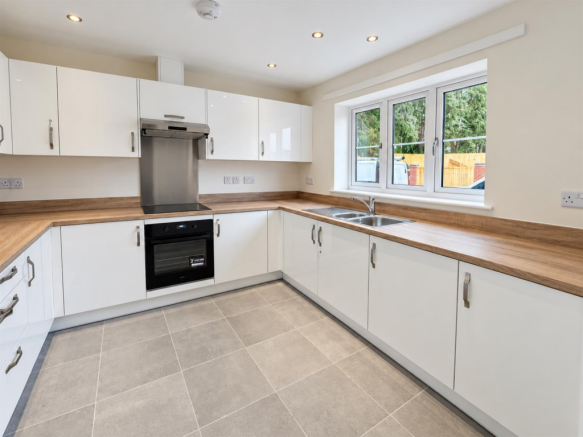 Modern L-Shaped Kitchen with Garden Views.png