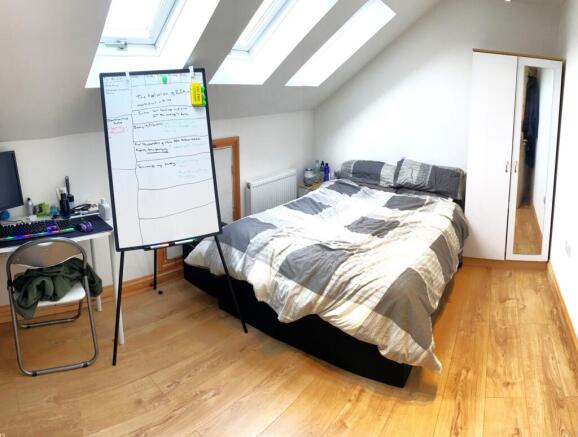 Bright and spacious double bedroom featuring a ...
